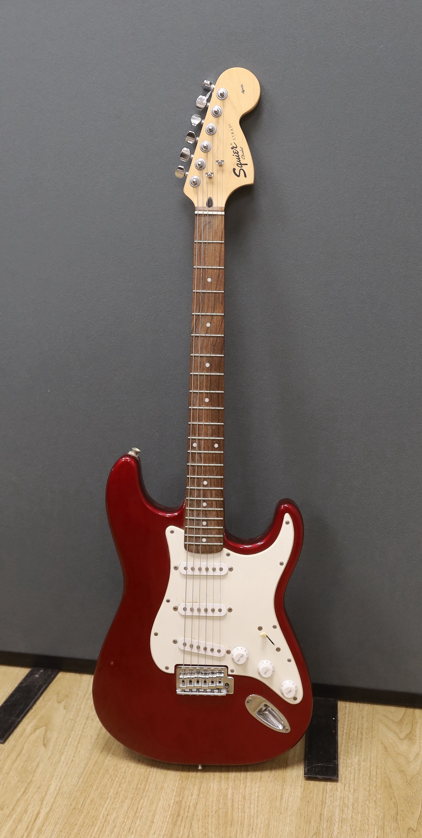 A Fender Squier Strat electric guitar with a soft case